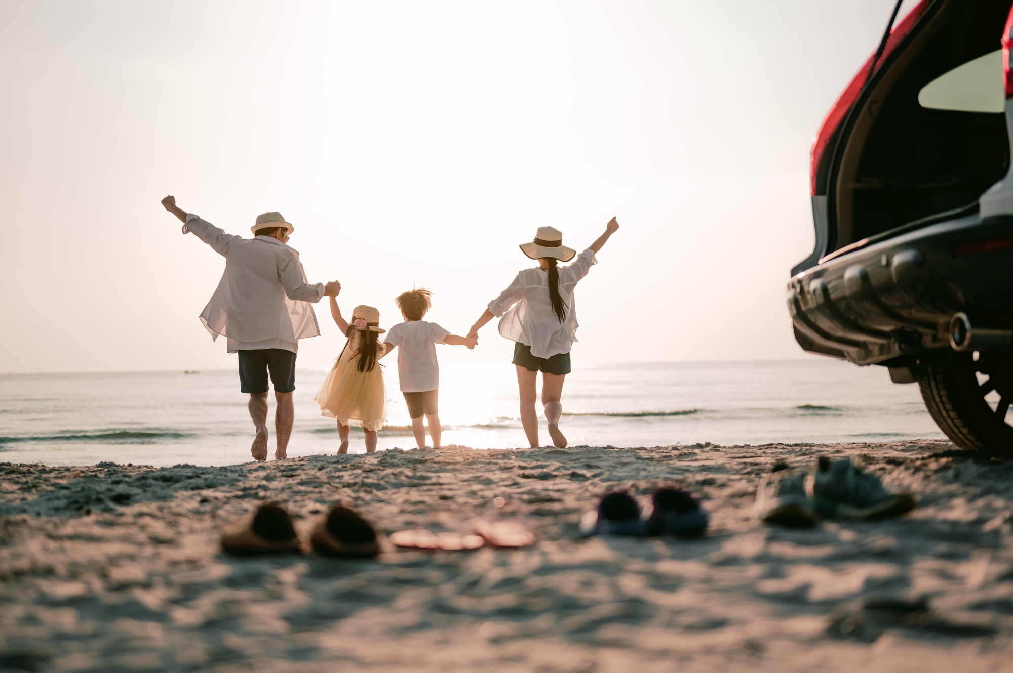 Asian Family vacation holiday, Happy family running on the beach in the sunset.