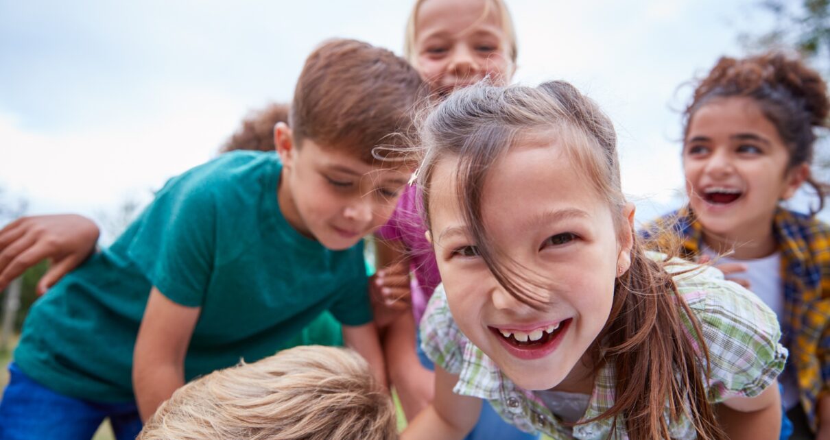 Portrait Of Children On Outdoor Activity Camping Trip Having Fun Playing Game Together