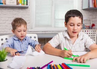 Kids draw at home together. Children are painting in kindergarten.