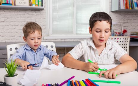 Kids draw at home together. Children are painting in kindergarten.