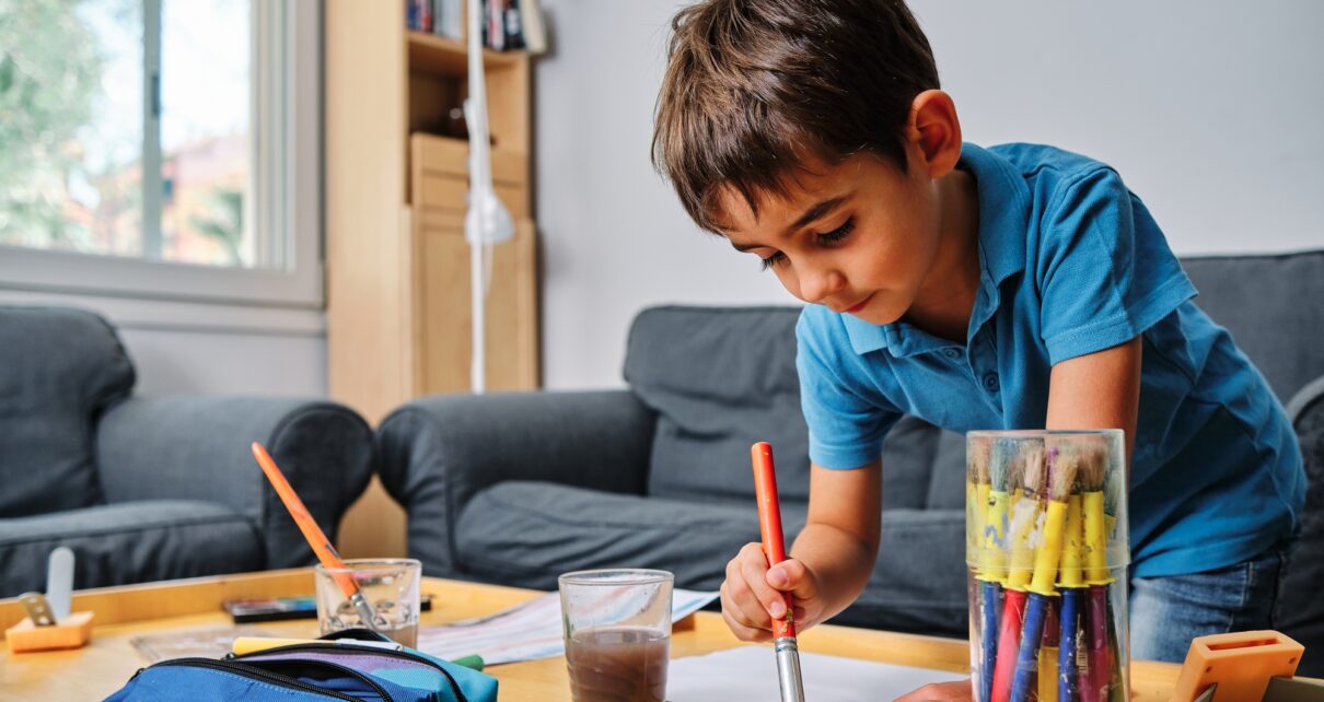 young kid playing with colors and drawing