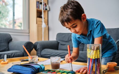 young kid playing with colors and drawing